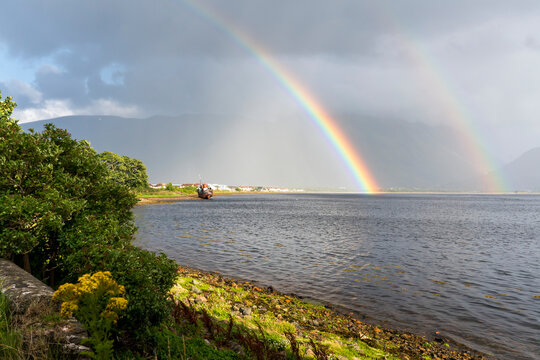 A rainbow stretches across the sky and lake Loch Eil near the Caledonian Canal at Corpach, Scotland; Corpach, Scotland