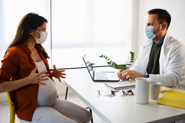 A Young pregnant woman having consultations with her obstetrician doctor at a private clinic