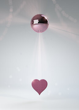 Valentine's Day pink heart invitation with sparkling disco dance mirror glitter ball with streamers, on white studio background. Bright, sophisticated and high-res image for print and screen.