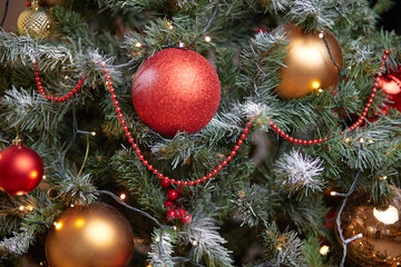 Close-up of balloons on a Christmas tree. Garlands of bokeh in the background. The concept of Christmas.
