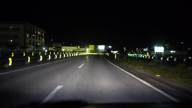 Night driving in Naha, Okinawa, Japan.  Reflectors guide the way.