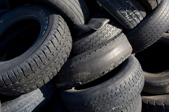 Close-up of a pile of old rubber vehicle tires with worn treads; Lake Placid, Florida, United States of America