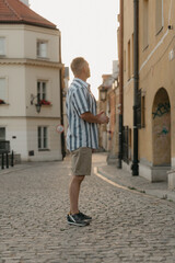 Fototapeta na wymiar A middle-aged male tourist is looking at the sights in an old European town