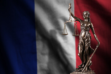 France flag with statue of lady justice and judicial scales in dark room. Concept of judgement and...