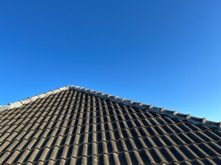 Brand new grey rooftop against blue sky in the morning.