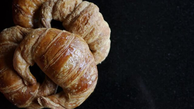  medialunas, argentinian sweet croissant over a black backdrop. copy space