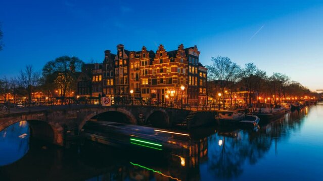 Amsterdam canal houses, bicycles and bridge in the Jordaan neighborhood by night in Netherlands timelapse 4k