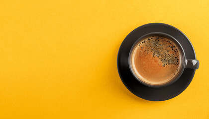 Aromatic coffee in dark grey cup on yellow background, top view with space for text. Banner design