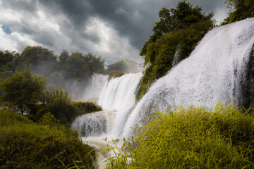Detian transnational waterfall, in a misty weather. It is the largest waterfall in Asia, spanning...
