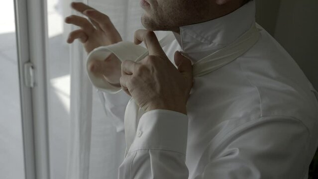 Groom getting ready on wedding day. Groom tying tie. Shot in 4K 60FPS for high quality slow motion. To purchase entire event raw at wholesale price email willneatheryyahoo.com.