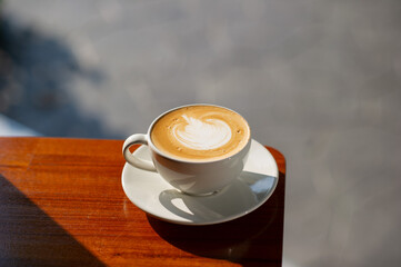 hot latte art coffee on wood table, relax time