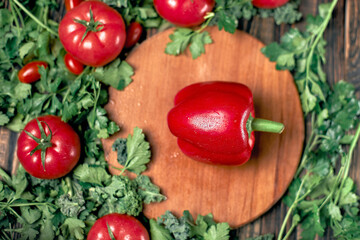 sweet paprika and fresh tomatoes on a wooden board.