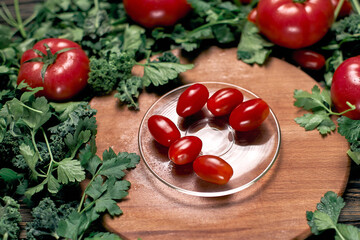 fresh red tomatoes on a glass plate.