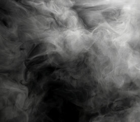 White puffs of smoke on a black background float mixing in bizarre chaotic patterns of thin threads
