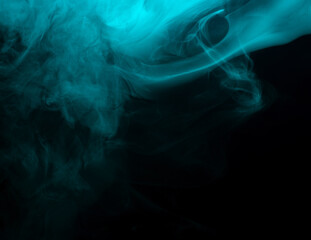 Abstract background of chaotically mixing clouds of turquoise smoke on a background of darkness
