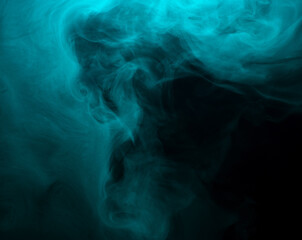 Abstract background of chaotically mixing clouds of turquoise smoke on a background of darkness