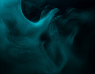 Abstract background of chaotically mixing clouds of turquoise smoke on a background of darkness