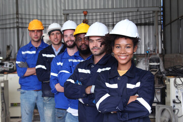 Smiling engineer team in industrial factory.