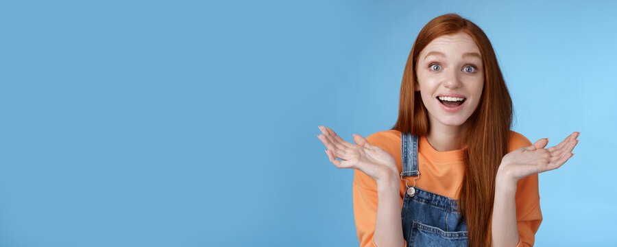 Amused Surprised Glad Young Redhead Girl Speechless Happy See Friend Came Back Hometown Wide Eyes Impressed Grinning Raise Hands Sideways Full Disbelief Standing Blue Background Joyful