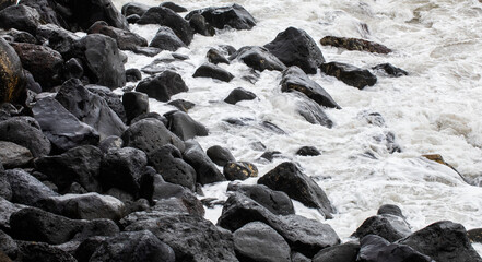 Große schwarze Lavasteine in der Brandung am Strand bei Rocha da Relva,Insel Sao Miguel, Azoren,...
