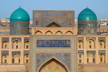 Portals and domes of ancient madrasahs on a sunny day. Historical center of Bukhara