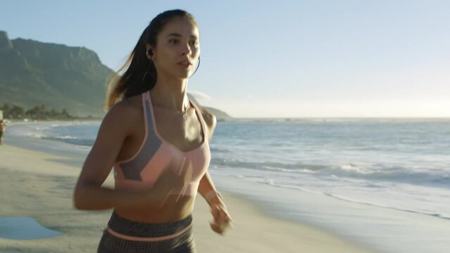 Beach, running and woman by the ocean for fitness, workout and exercise for runner health. Sports, marathon training and cardio energy of a athlete by the sea in nature on a morning run outdoor