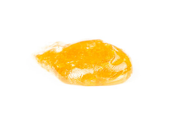 gold cannabis resin extract isolate on white background,yellow dab smear