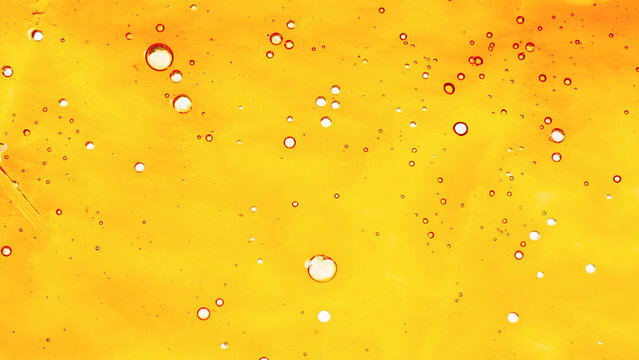 texture yellow golden cannabis wax, marijuana shatter resin concentrate background