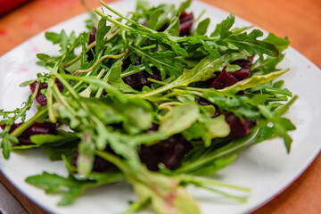 Preparing a salad of arugula and beets. Lots of greens for cooking.