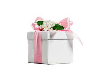 White gift box with pink ribbon bow and white spring flowers on top. Cut out without background.....