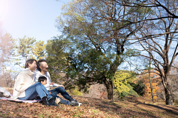 笑顔でニコニコする家族の公園でのポートレート　秋冬 仲良し