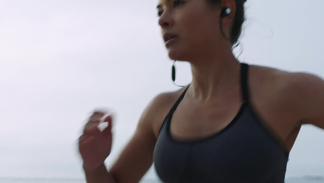 Woman, music earphones or running by beach, ocean or sea in cardiology wellness, marathon training or Canada morning race. Runner, sports athlete or nature sprinter listening to fitness radio podcast