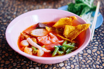 Close up of noodle in pink broth ( Yentafo ) - delicious and healthy street food in Thailand