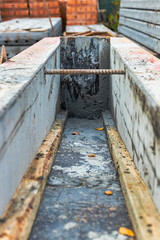 Reinforced concrete foundation of a modern monolithic residential building. Prepared formwork with reinforcing mesh for pouring concrete. Monolithic construction technologies.