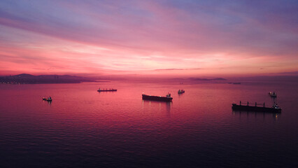 Naklejka premium aerial view of cargo ships before sunrise in sea of marmara