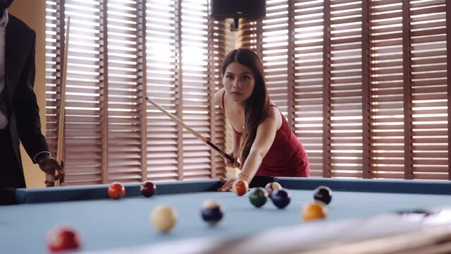 Woman Taking A Shot At A Game Of Pool
