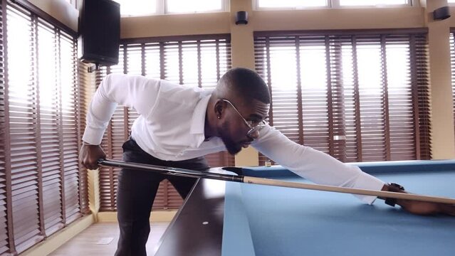 Man Concentrating On Taking A Pool Shot