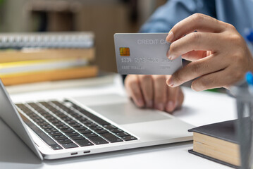 businessman using credit card and laptop to login to internet bank.Online shopping, e-commerce, internet banking, and financial transactions payments via e-bank application concept.