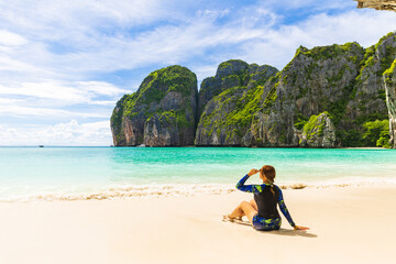 Young Asian lady tourist on the  the beach, Ma Ya bay, Phi Phi island  krabi province Thailand.