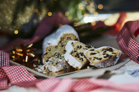 Christmas stollen, known as Christstollen - classic Christmas bread. Christmas tradition with bokeh background. Festive background