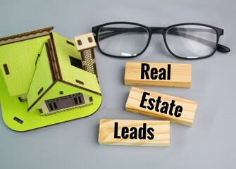 house models, glasses and words Real Estate Leads. the concept of real estate property.