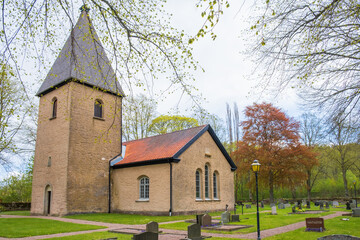 Fototapeta na wymiar Church in the countryside and cemetery