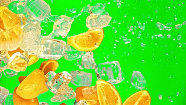 Fresh orange fruit, ice cube and drops juicy or alcohol beverage or energy drink or shake soda pop splash pours in super slow motion 1000 fps. Cold orange slices, ice cube and liquid, green chromakey