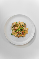 ravioli in an alfredo sauce with sun-dried tomatoes and parsley