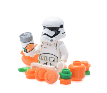 Lego minifigure of warrior Star Wars with orange fruits and drink can isolated on white. Editorial illustrative image of popular plastic toy constructor.