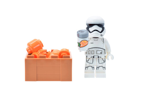 Lego minifigure of warrior Star Wars with orange fruits and drink can isolated on white. Editorial illustrative image of popular plastic toy constructor.