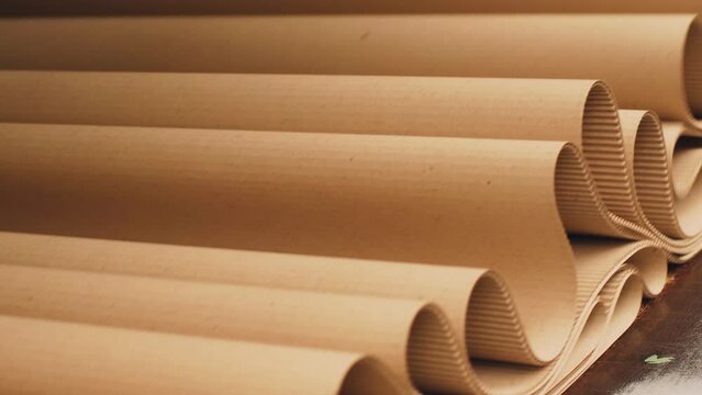 Production of cardboard packaging. Cardboard moves out of the machine. Paper box