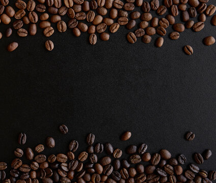 Roasted coffee beans border isolated on black background with copy space