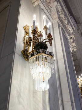 Bucharest, Romania - April 6, 2022: Bright crystal wall light on one of the halls inside Parliament Palace building, Romania. 