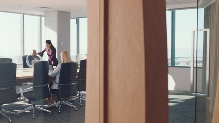 Corporate, office and conference room with woman at meeting walking with legal documents at diverse company. Executive lawyer planning, strategy and development at workplace in New York, USA.